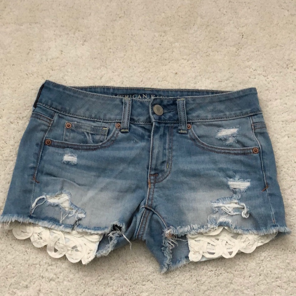 Light wash jean shorts with lace